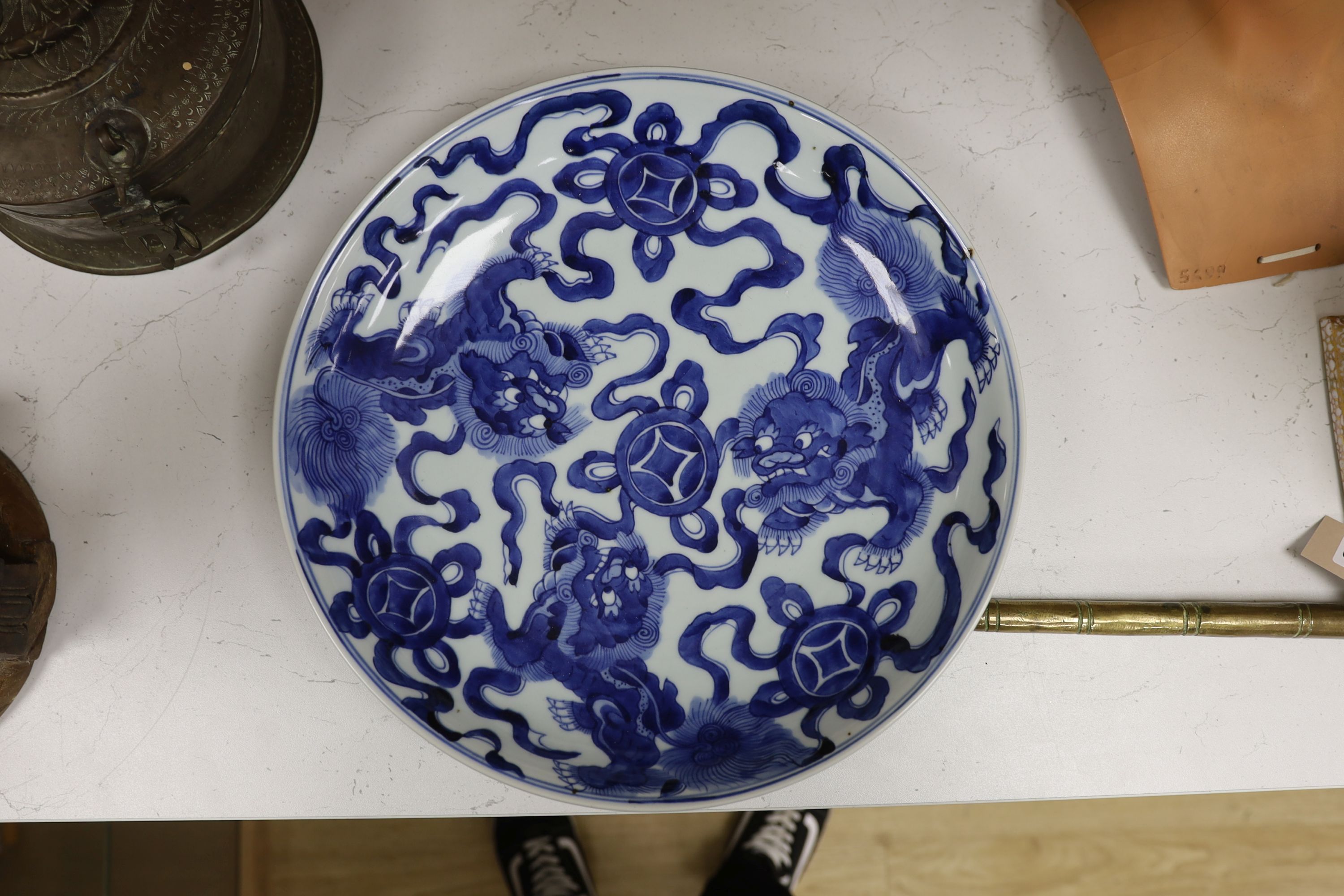 A Chinese blue and white ‘Buddhist lion’ dish, channel moulded foot, 36cm diameter